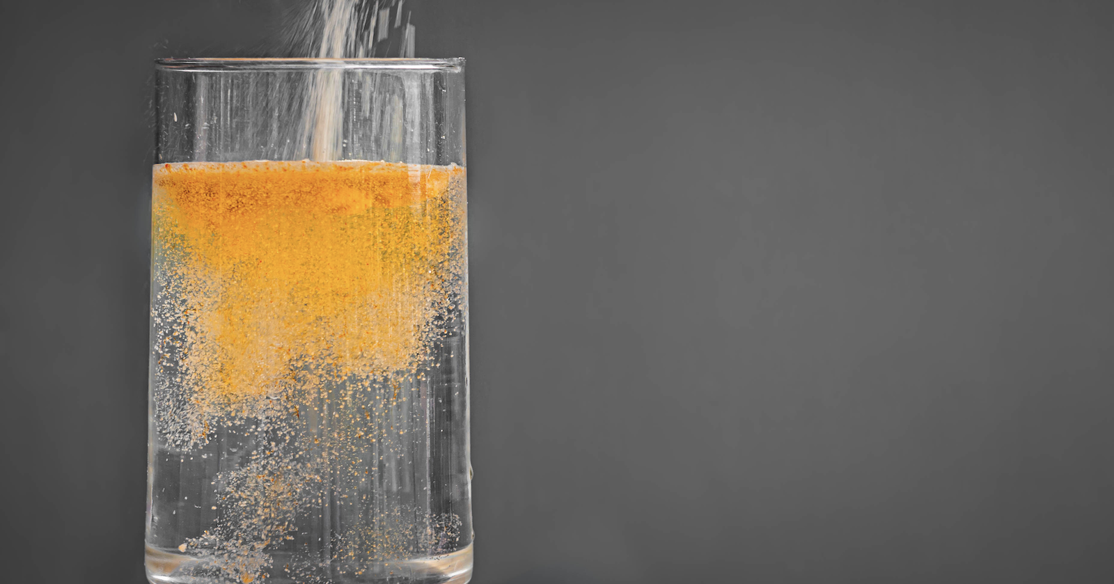 Drip Drop vs Liquid IV: DripDrop ORS solution being poured into a glass of water