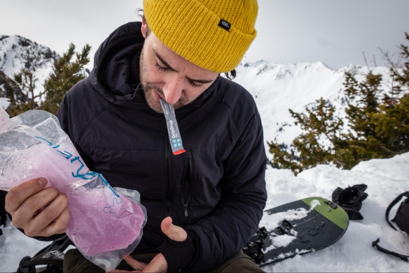 hydration bladder: Snowboarder preparing DripDrop ORS while outdoors