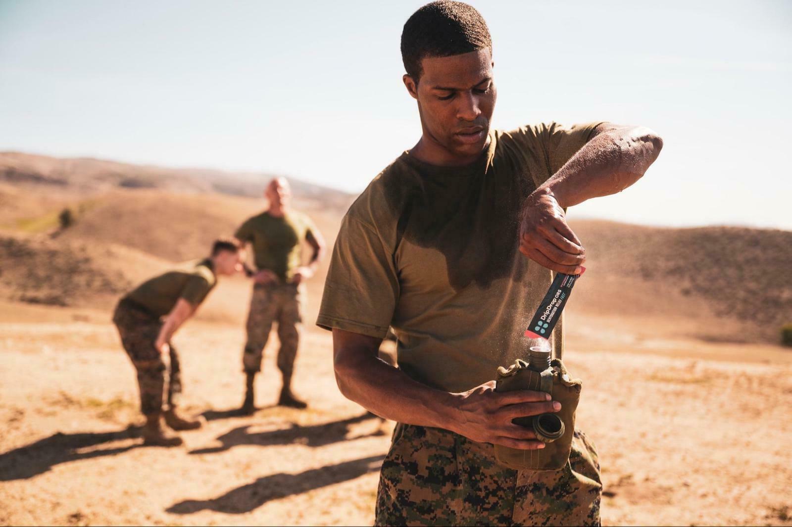 army pouring DripDrop ORS in his bottle