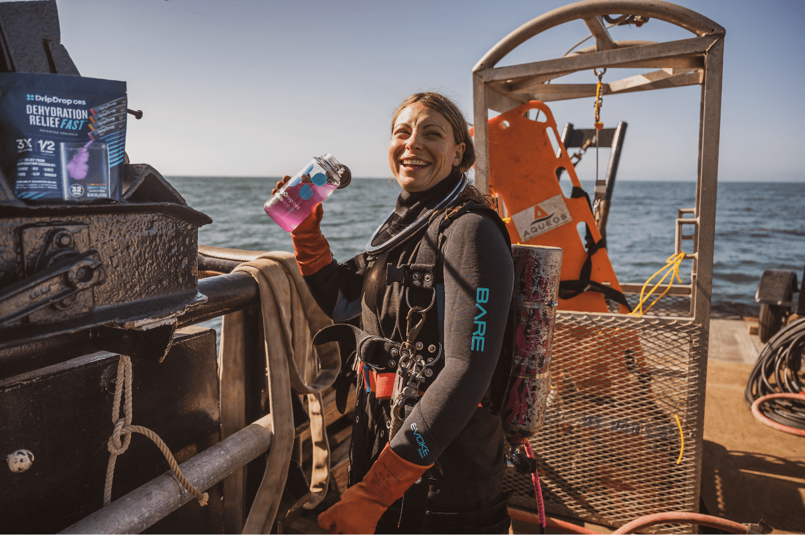 How to rehydrate fast: diver drinking DripDrop on a boat