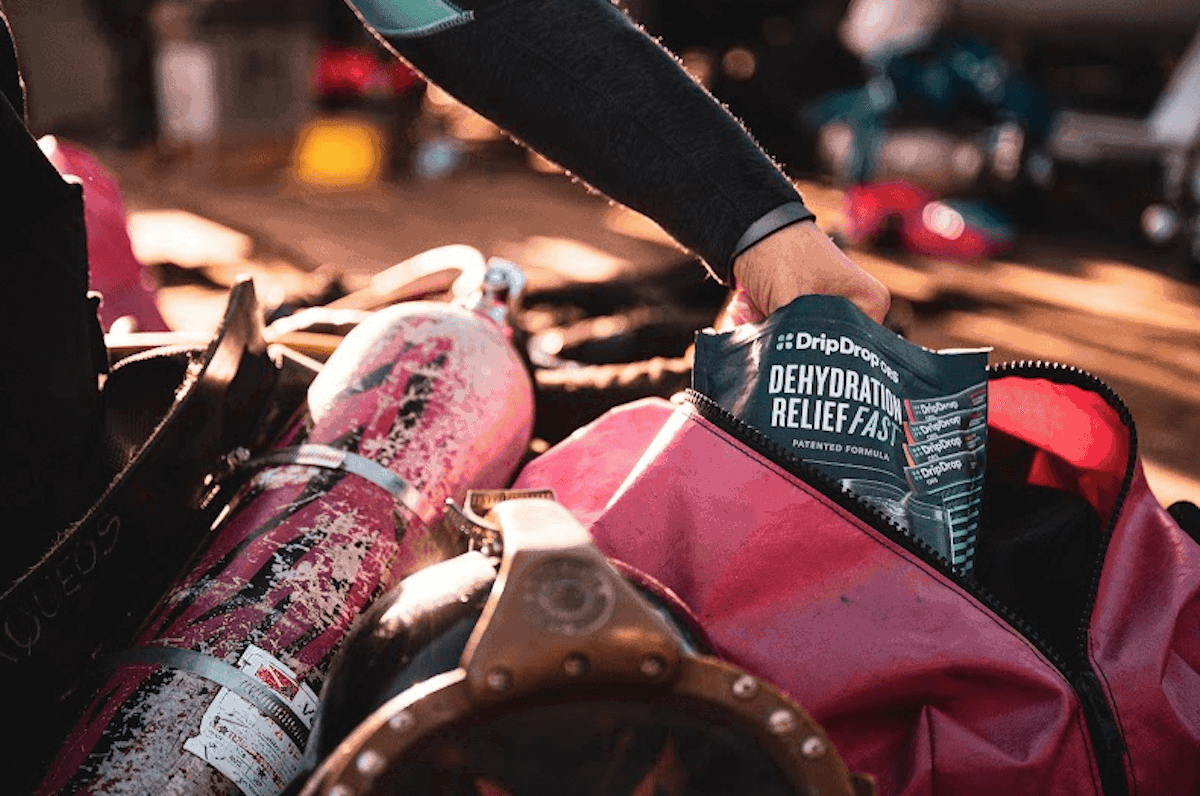 Diver getting a DripDrop sachet from a bag