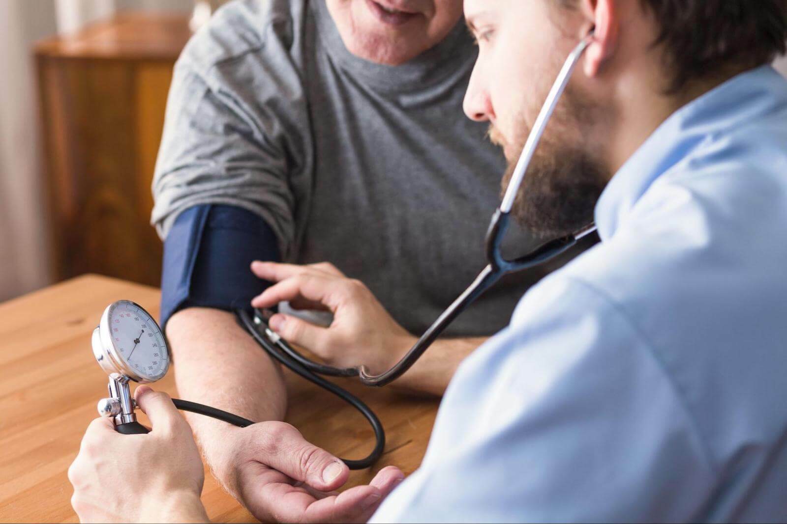 Cold sweats: doctor checking the BP of his patient