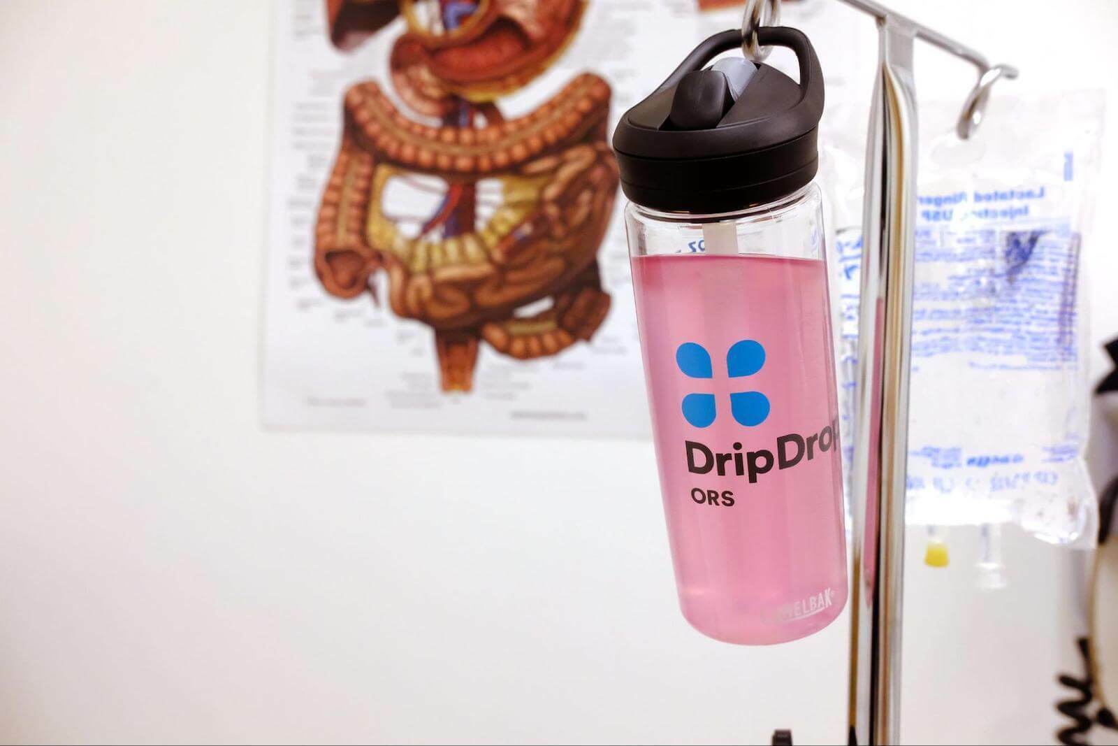 Electrolytes benefits: DripDrop tumbler hanging from an IV stand