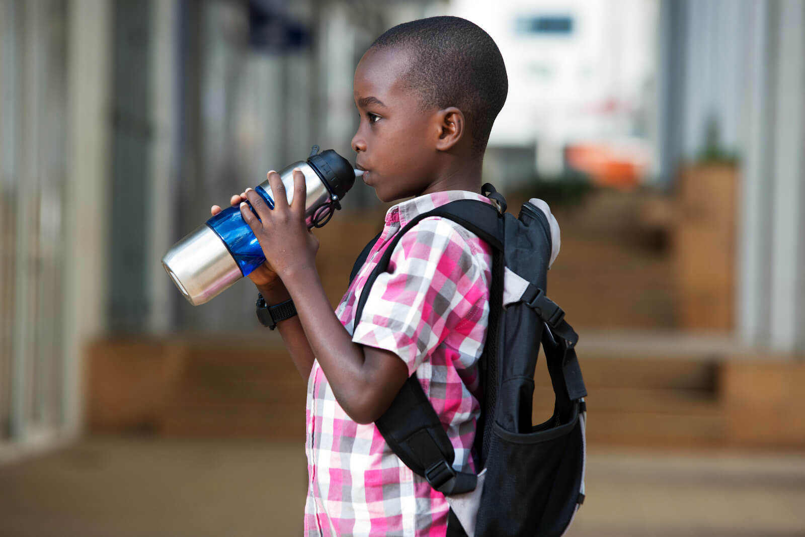 Oral rehydration salts: little boy drinking from a tumbler