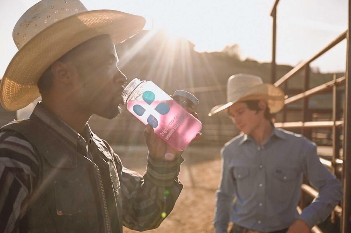 How long does it take to recover from dehydration: man at a ranch drinking DripDrop ORS
