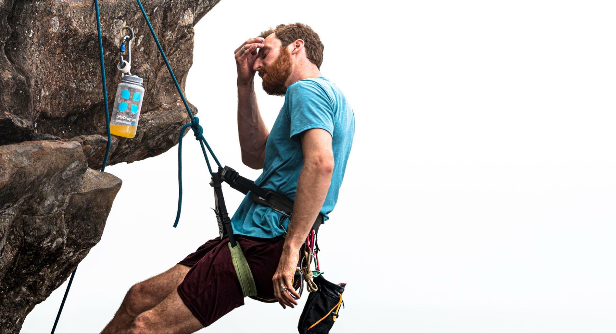 how to hydrate skin: man in a rappel holding his forehead