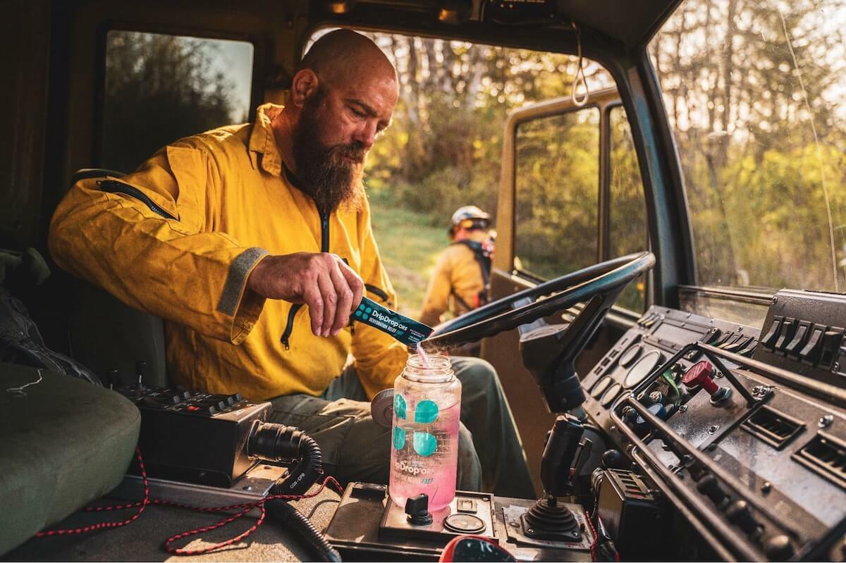 Man pouring DripDrop ORS into his tumbler