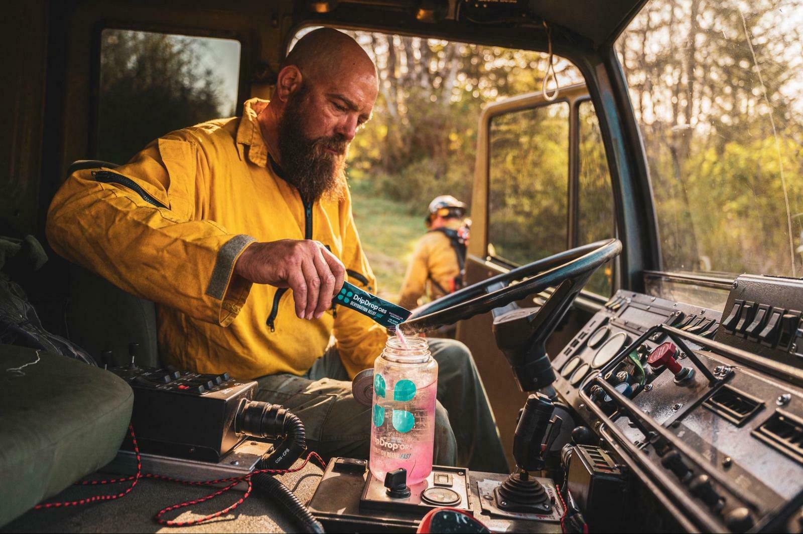 how to prevent muscle cramps: man pouring DripDrop ORS in his DripDrop ORS bottle