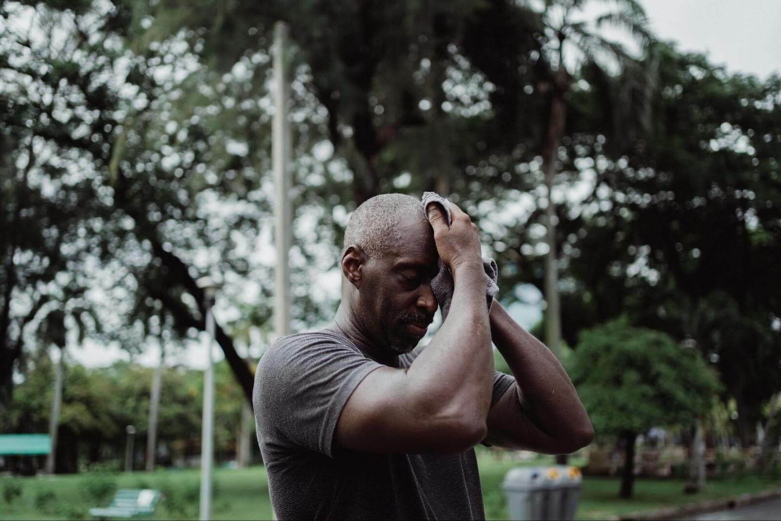 Man wiping his sweat using a towel