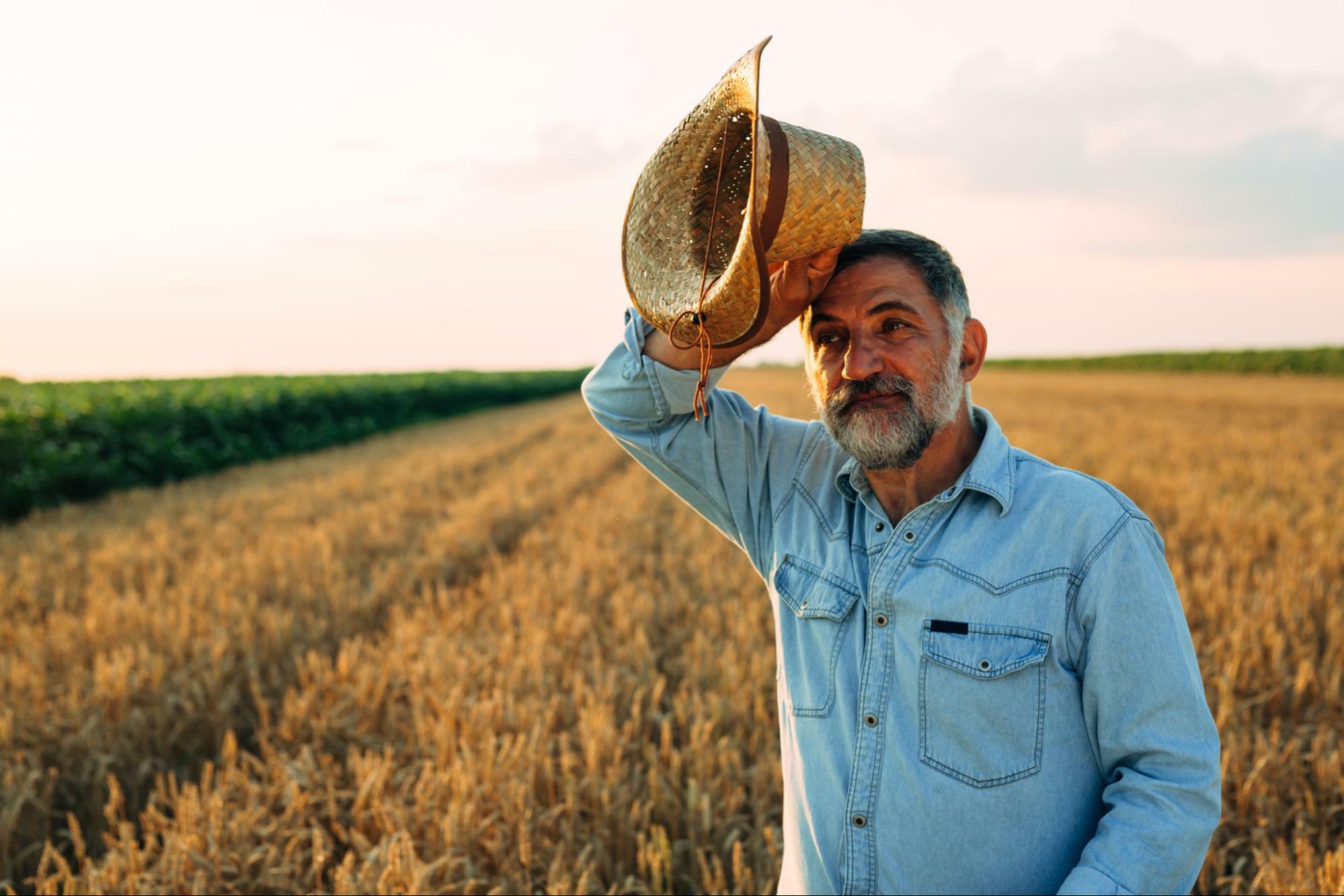 best water to drink for health: old man on the field holding his hat