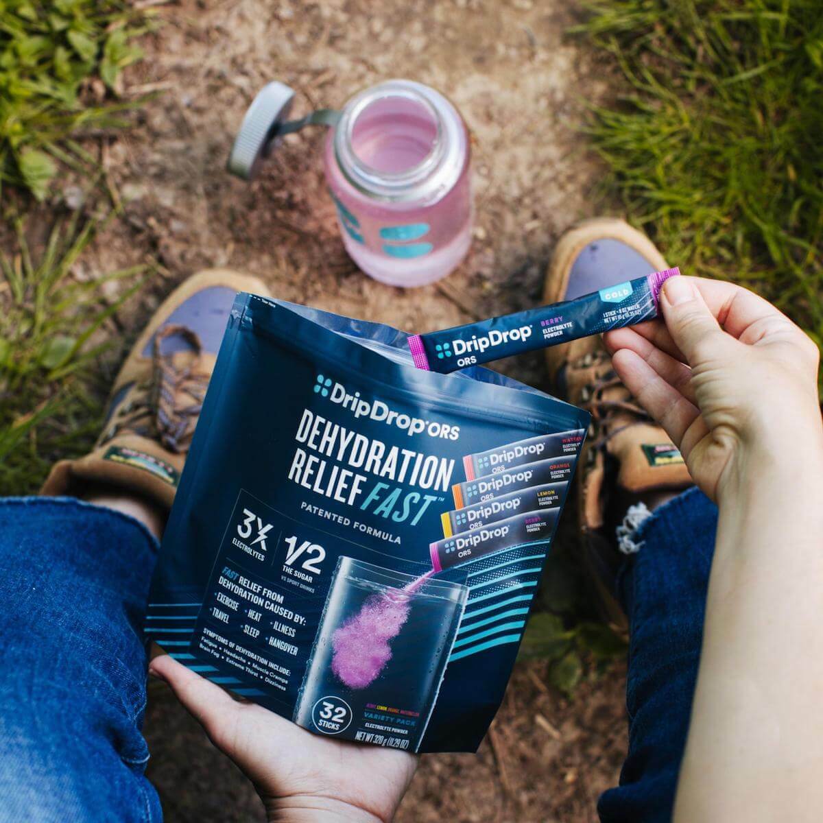 Person getting a sachet of DripDrop ORS from a pack