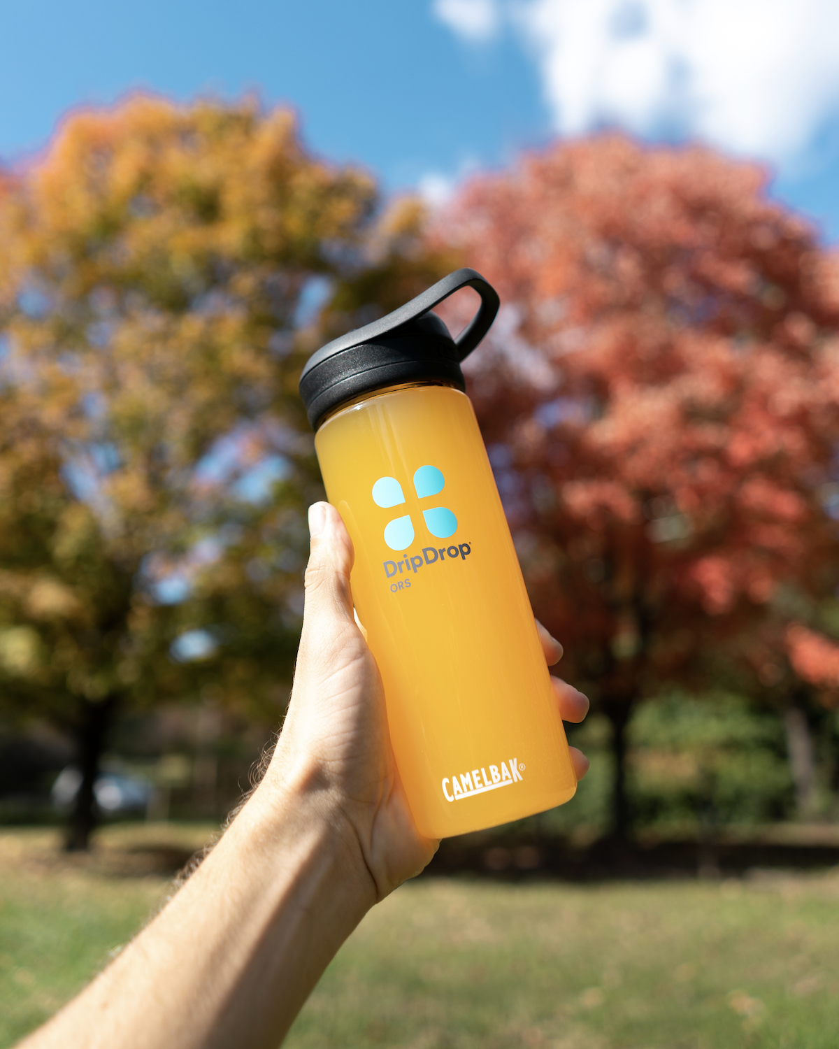 Person holding a tumbler with DripDrop ORS