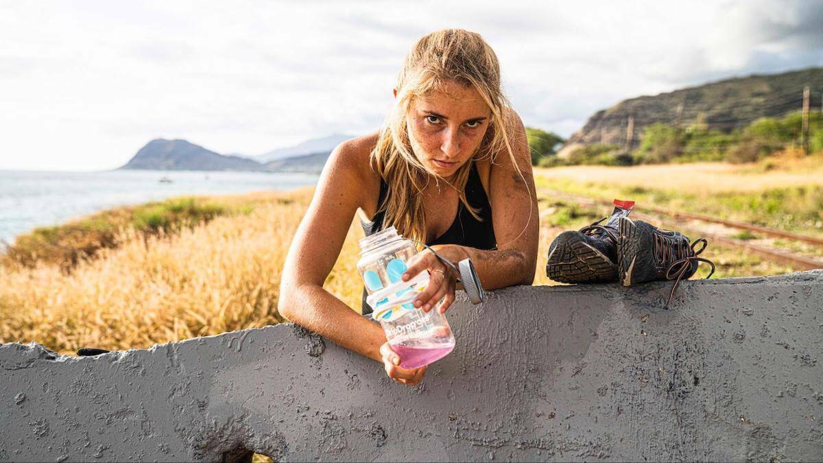 Not drinking enough water: tired woman holding an almost empty DripDrop tumbler