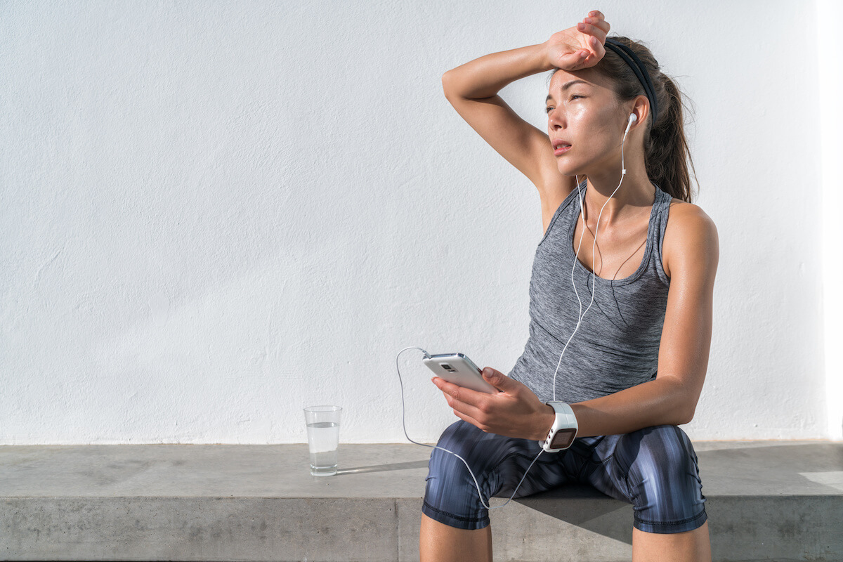 How long does it take to recover from dehydration: tired and perspiring woman, wiping off her sweat
