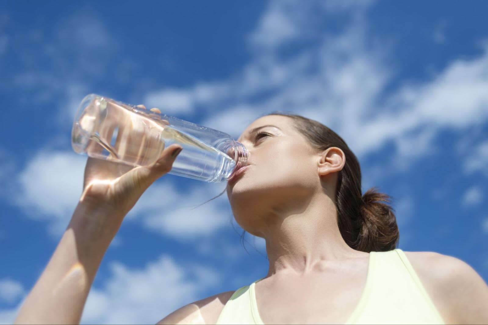 Can you sweat out a cold: woman drinking water from a tumbler